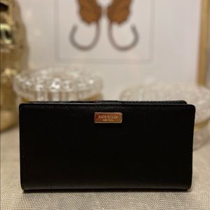 Kate Spade bifold black wallet with zipper and gold hardware.